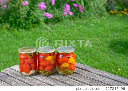 Homemade salted pickled tomatoes preserved in glass jars Homemade salted pickled tomatoes preserved in glass jars 117252496