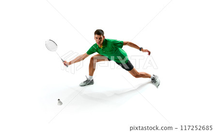 Determination and endurance on court. Focused male badminton player practicing, playing with intensity isolated on white background Determination and endurance on court. Focused male badminton player practicing, playing with intensity isolated on white background 117252685