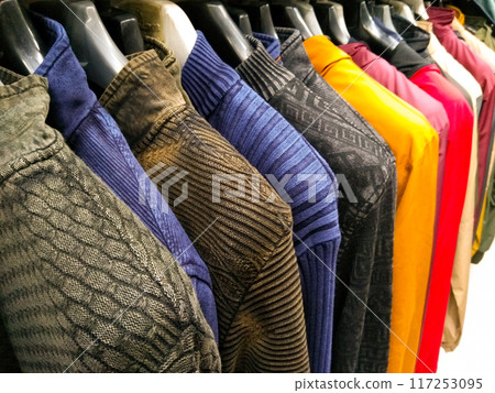 multi color dress sherwani kurta hanging from hangar in a garment shop for sale 117253095