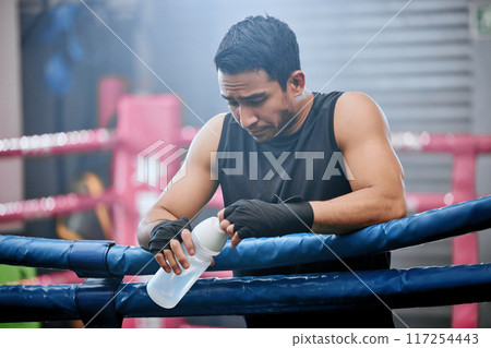 Sad, lose and defeated athlete looking tired after workout, unhappy and drinking water after boxing for fitness. Young, sporty and Asian man breathing heavily, resting and taking break from exercise 117254443