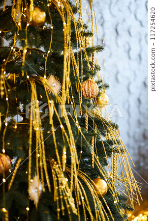 Close up of decorated Christmas tree with golden baubles and ornaments. Shallow Depth of Field Close up of decorated Christmas tree with golden baubles and ornaments. Shallow Depth of Field 117254620
