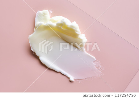 Texture of cosmetic butter on a pink background. Showcasing a thick and nourishing texture. 117254750