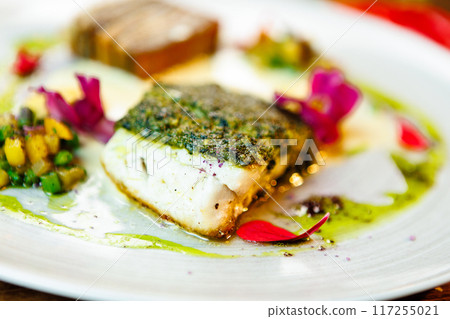 Pike-perch fillet. Potato gratin, warm yellow beet-turkey bean salad, parmesan dressing. Delicious seafood fish closeup served on a table for lunch in modern cuisine gourmet restaurant 117255021