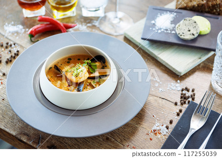Shrimp Bisque with Seafood. King prawn, blue mussels, cod, whipped cream. Delicious traditional food closeup served for lunch in modern gourmet cuisine restaurant 117255039