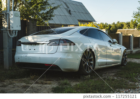 A broken Tesla model s, standing on bricks, somewhere in the village 117255121
