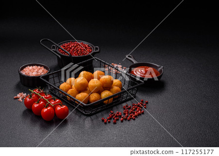 Cheese or potato balls breaded with salt, spices and herbs 117255177