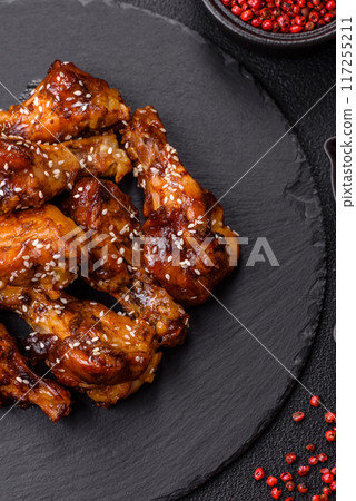 Delicious crispy baked chicken wings in teriyaki sauce 117255211