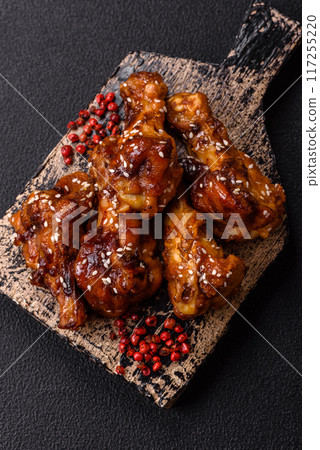 Delicious crispy baked chicken wings in teriyaki sauce 117255220
