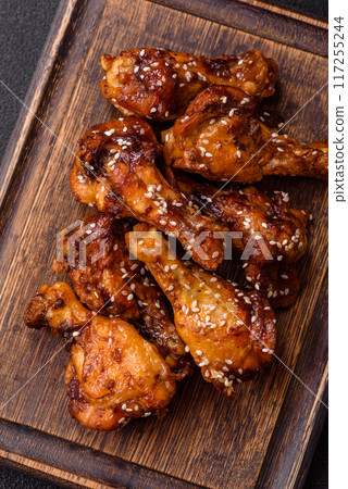 Delicious crispy baked chicken wings in teriyaki sauce 117255244