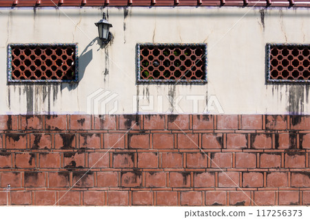 Chinese red brick walls with lattice windows Chinese red brick walls with lattice windows 117256373