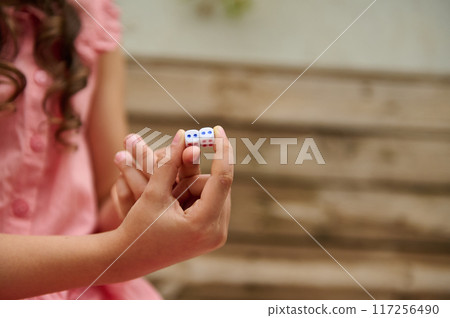 A mother and daughter spend quality time baking croissants together in a cozy kitchen. The little girl thoughtfully arranges baked goods while learning the art of cooking. A mother and daughter spend quality time baking croissants together in a cozy kitchen. The little girl thoughtfully arranges baked goods while learning the art of cooking. 117256490