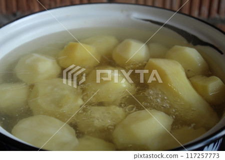Cooking potatoes. Potatoes in a saucepan are cooked over the fire. Cooking a potato dinner 117257773