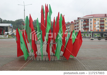 Red and green flags on a stand in the city. Decorations for the holiday 117257803