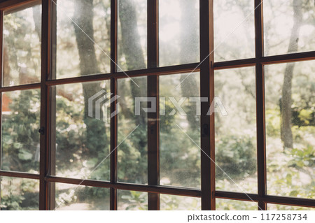 The view through the handmade glass windows of a wooden building 117258734