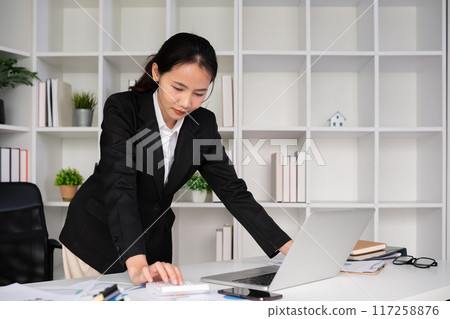 Young Asian businesswoman in the office is disappointed and stressed about her performance in the company. Young Asian businesswoman in the office is disappointed and stressed about her performance in the company. 117258876