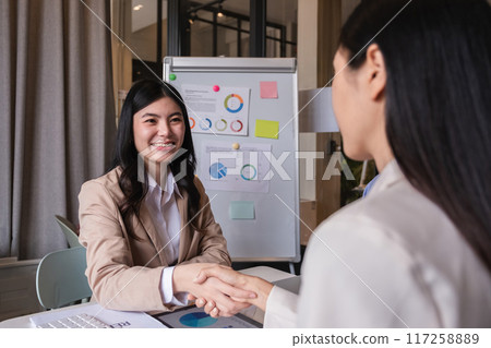 Successful negotiation, handshake, two businessmen shaking hands with partners to celebrate successful completion of deal Successful negotiation, handshake, two businessmen shaking hands with partners to celebrate successful completion of deal 117258889