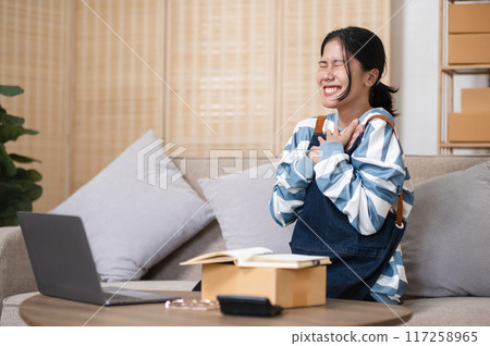 Small business owners celebrate success for online shopping business sales. Small business owners celebrate success for online shopping business sales. 117258965