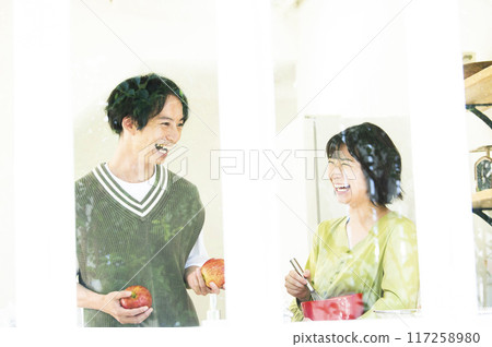A couple talking while cooking A couple talking while cooking 117258980