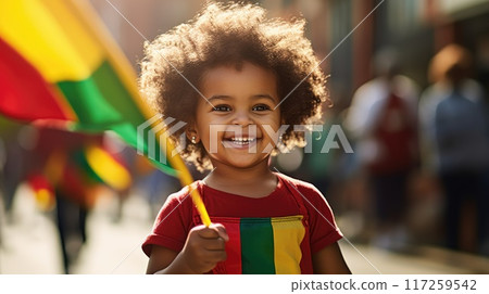 Happy Child Holding red, green and yellow flag symbolizing Juneteenth Freedom and African liberation day. Black life matters. Black history month. 117259542