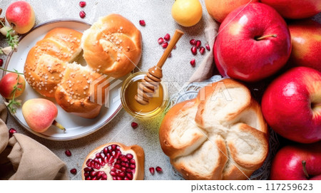 Freshly baked Challah bread, apples and pomegranate on white table for the celebration of Jewish New Year Rosh Hashanah 117259623