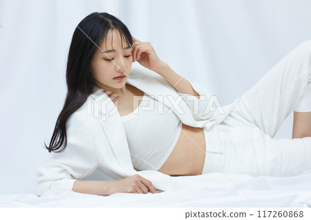 Portrait of a young woman in a white jacket 117260868