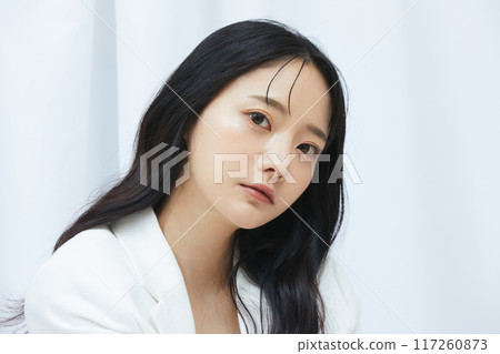 Portrait of a young woman in a white jacket 117260873