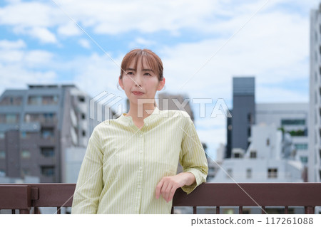 A young woman living her own life positively under the blue sky A young woman living her own life positively under the blue sky 117261088