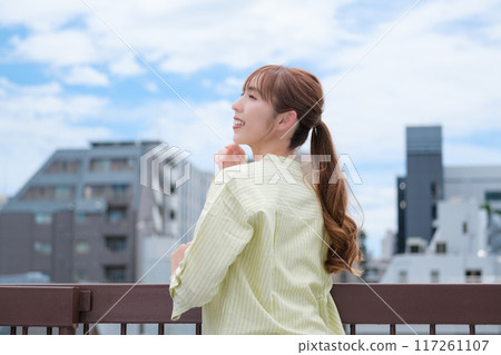 A young woman living her own life positively under the blue sky 117261107