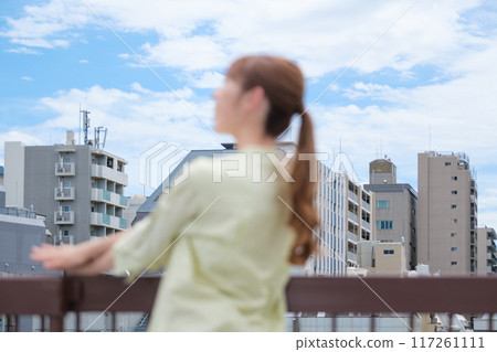 A young woman living her own life positively under the blue sky A young woman living her own life positively under the blue sky 117261111