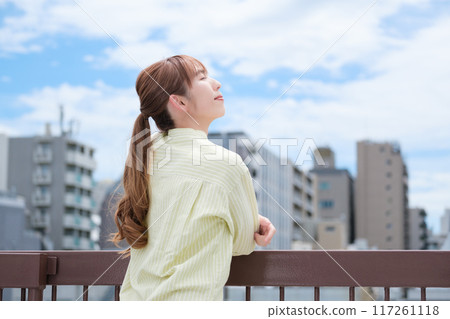 A young woman living her own life positively under the blue sky 117261118