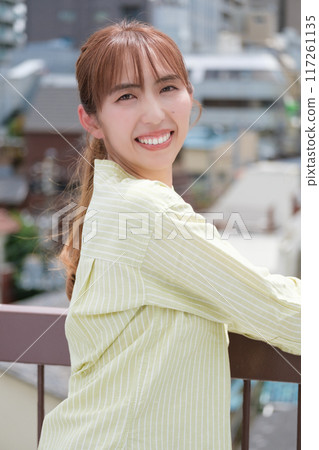 A young woman living her own life positively under the blue sky 117261135