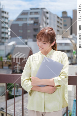 A young woman living her own life positively under the blue sky A young woman living her own life positively under the blue sky 117261139