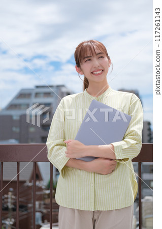 A young woman living her own life positively under the blue sky 117261143