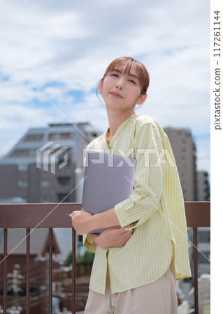 A young woman living her own life positively under the blue sky 117261144