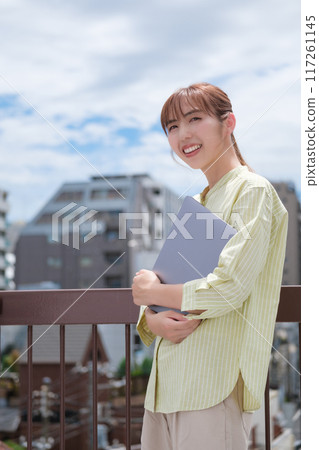 A young woman living her own life positively under the blue sky 117261145