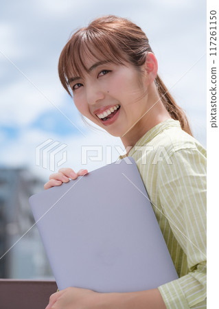 A young woman living her own life positively under the blue sky A young woman living her own life positively under the blue sky 117261150