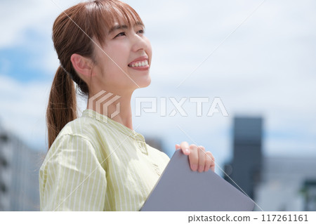 A young woman living her own life positively under the blue sky 117261161