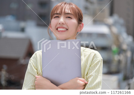 A young woman living her own life positively under the blue sky A young woman living her own life positively under the blue sky 117261166