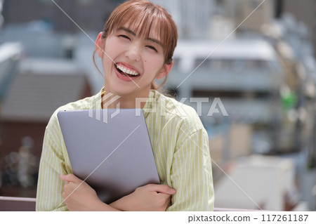 A young woman living her own life positively under the blue sky 117261187