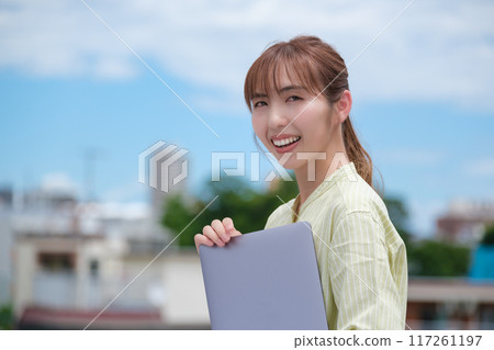 A young woman living her own life positively under the blue sky A young woman living her own life positively under the blue sky 117261197