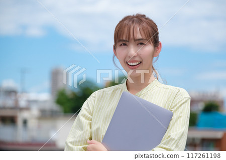 A young woman living her own life positively under the blue sky A young woman living her own life positively under the blue sky 117261198