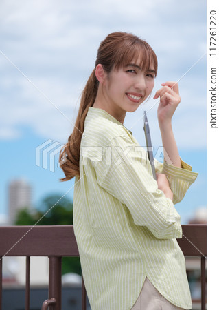 A young woman living her own life positively under the blue sky A young woman living her own life positively under the blue sky 117261220