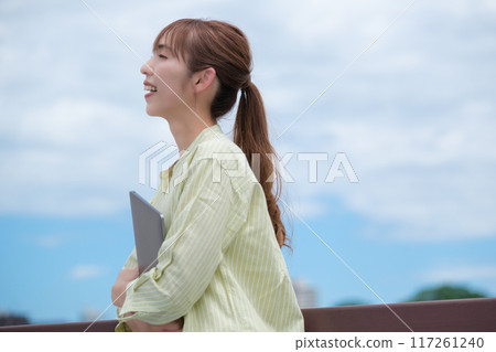 A young woman living her own life positively under the blue sky A young woman living her own life positively under the blue sky 117261240