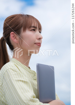 A young woman living her own life positively under the blue sky 117261244