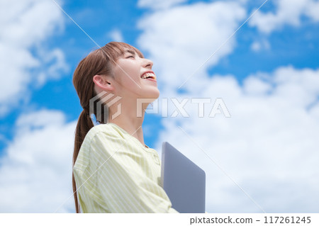 A young woman living her own life positively under the blue sky 117261245