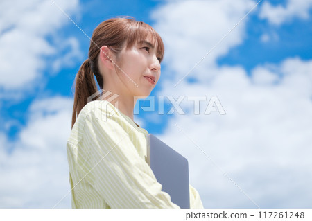 A young woman living her own life positively under the blue sky A young woman living her own life positively under the blue sky 117261248