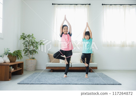 A child stretching in the living room 117264872