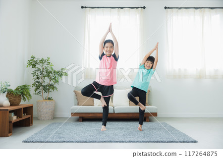 A child stretching in the living room A child stretching in the living room 117264875