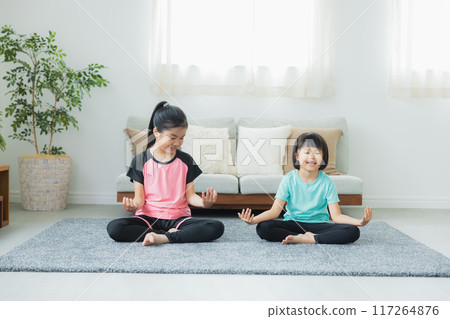 A child stretching in the living room A child stretching in the living room 117264876