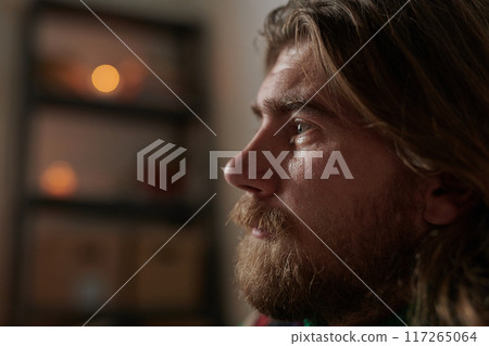 Contemplating Bearded Man with Soft Lighting Indoors Contemplating Bearded Man with Soft Lighting Indoors 117265064